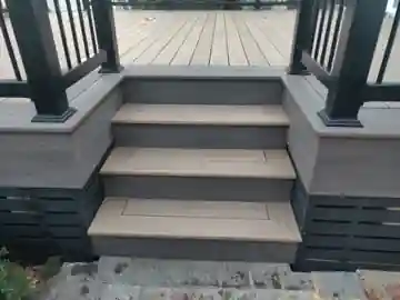 Composite deck stairs with picture-frame treads, dark fascia, skirting and black aluminum railing