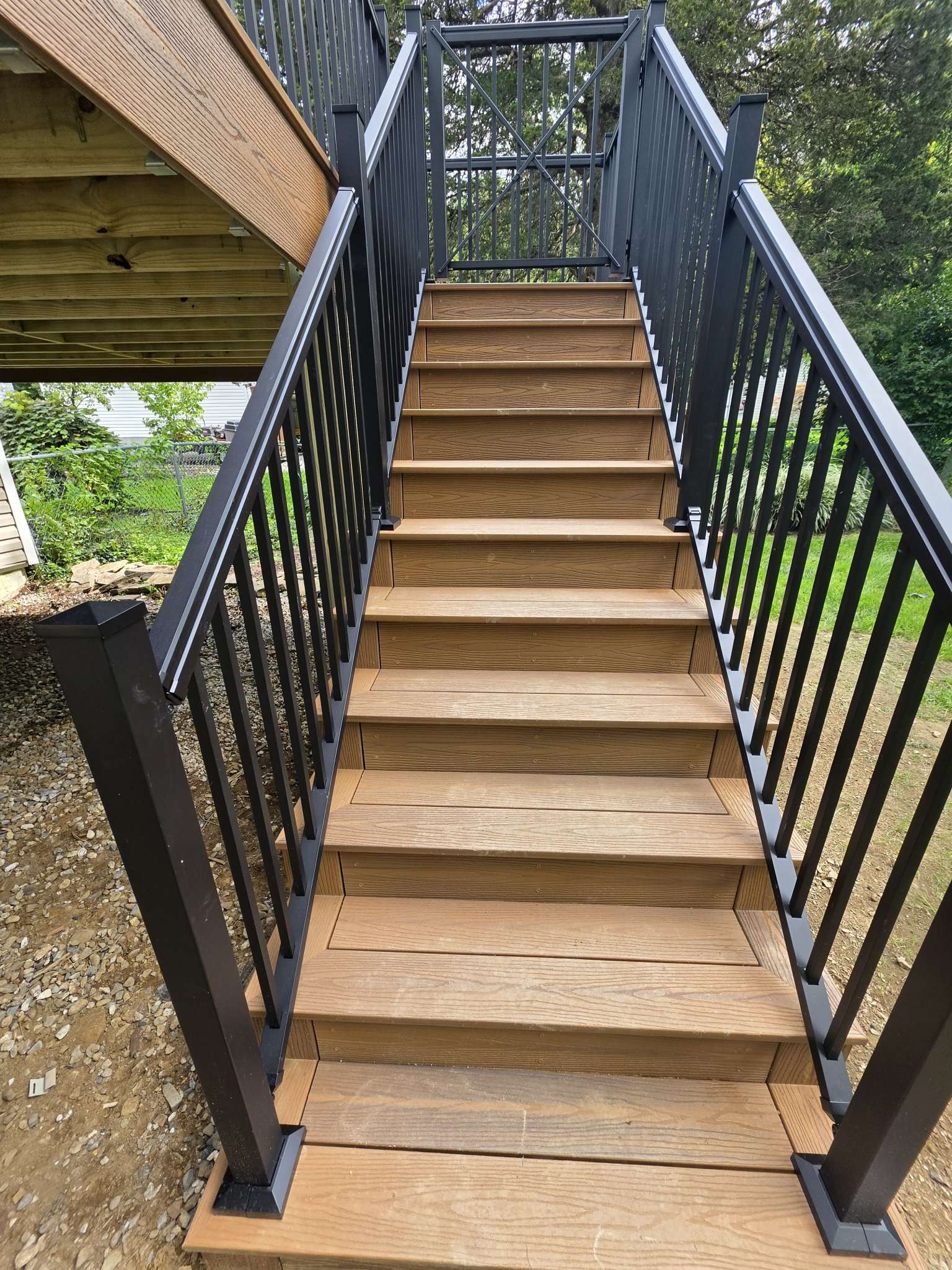 Wood stair framing and under-deck structure at a deck job site